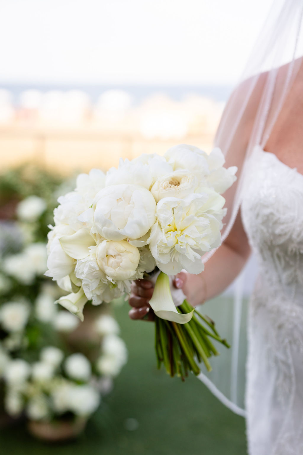 All white wedding bouquet with calla lilies, peonies, and roses