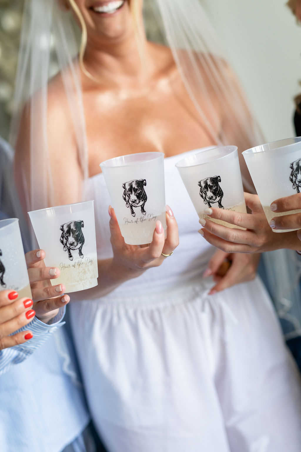 Bride and her friends holding adorable custom cups with an illustration of their dog and the phrase Hair of the Dog