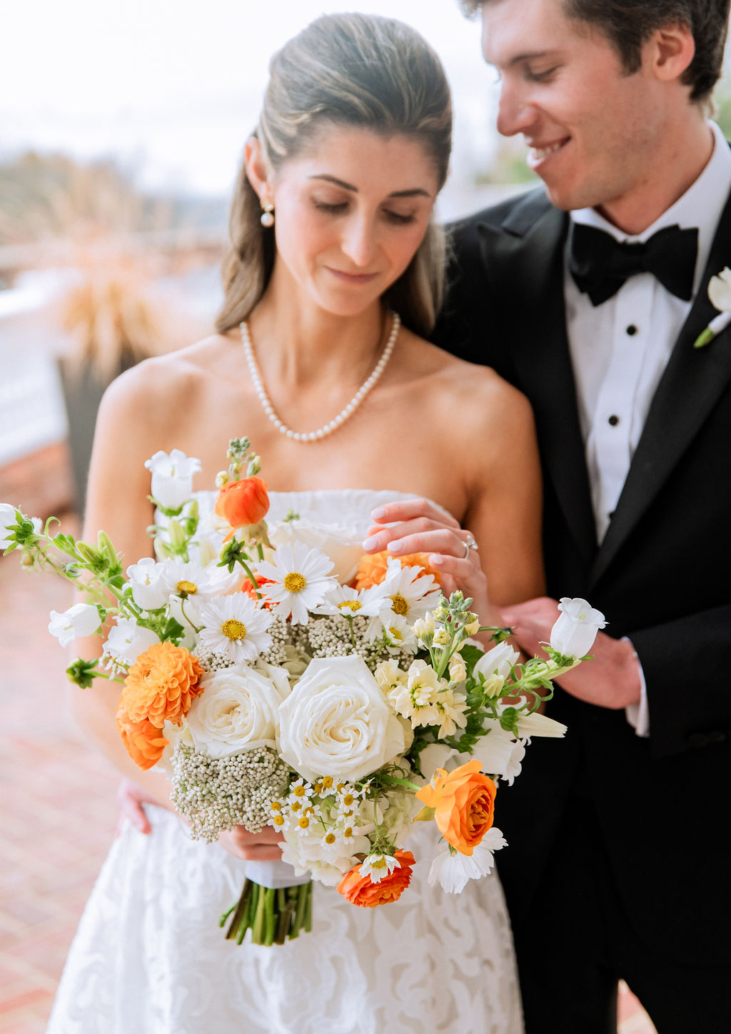 Orange and white wedding bouquet with tiny daisies and dahlias