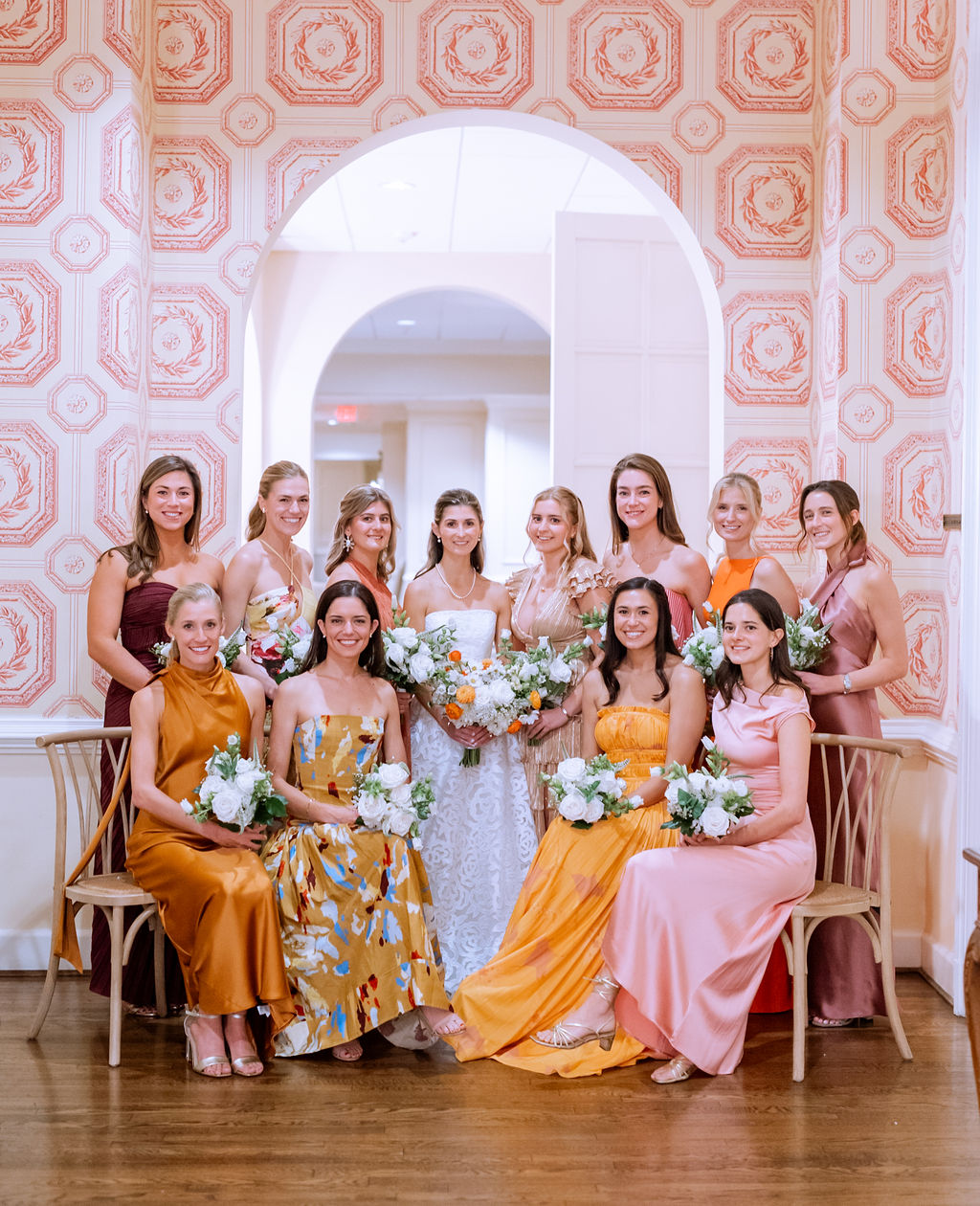 Colorful fall themed bridesmaid dresses in burgundy, orange, and rust