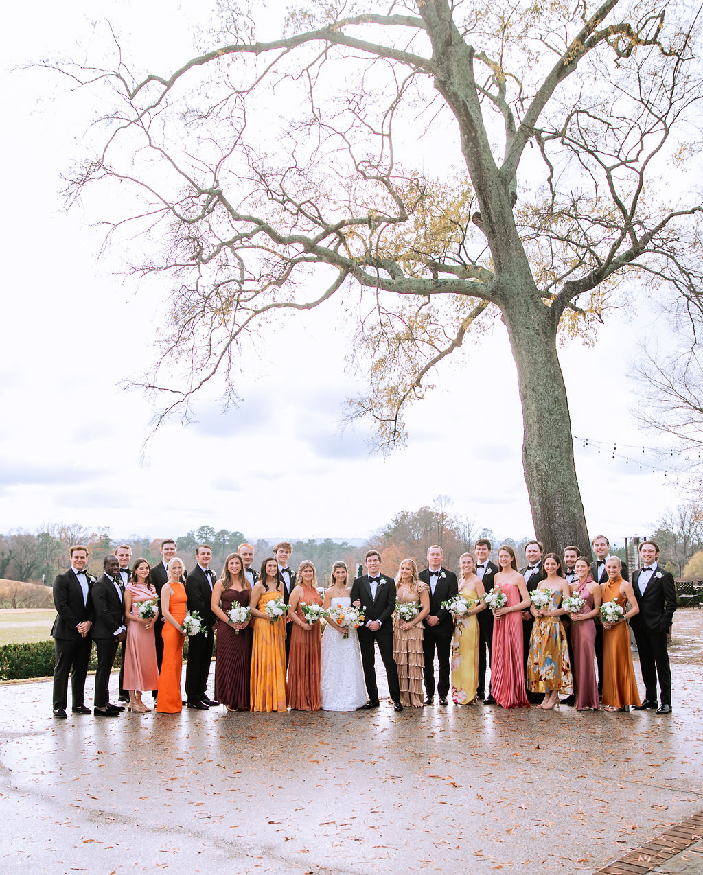 Large wedding party photo with 13 groomsmen and 11 bridesmaids