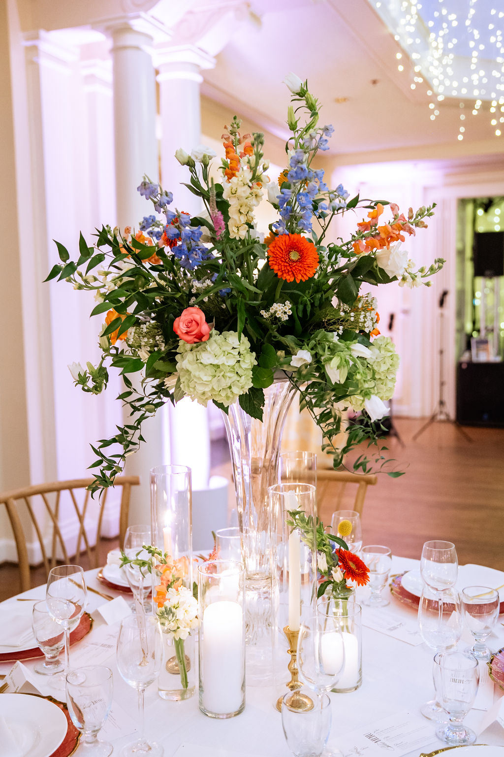 Tall wedding floral centerpiece with colorful flowers inspired by University of Virginia