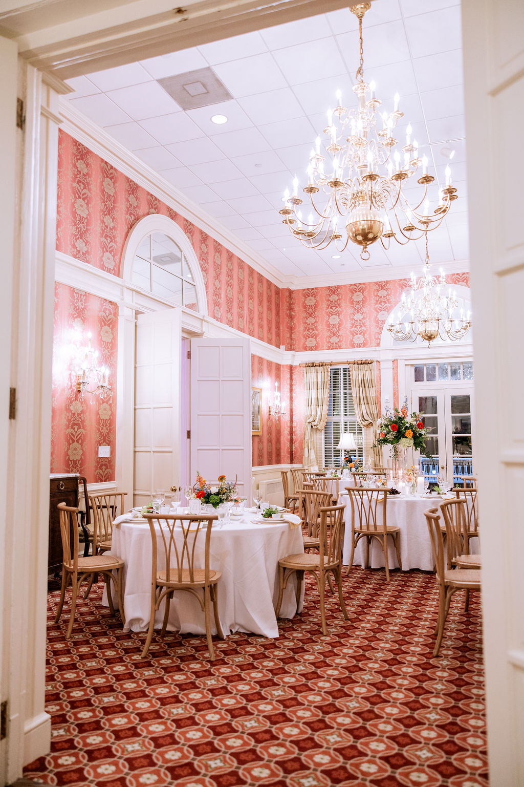 Maximalist traditional country club wedding reception with round tables and colorful flowers