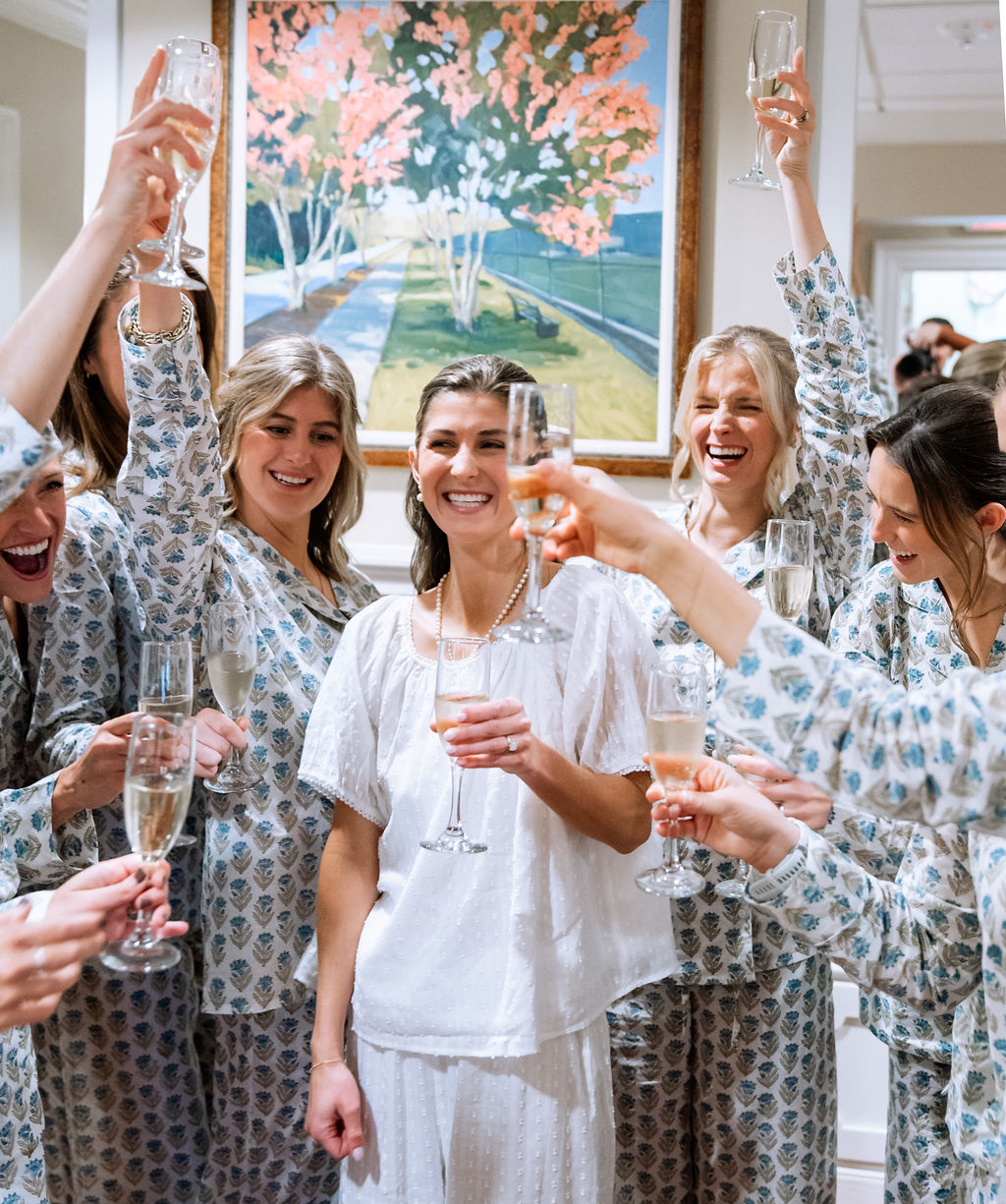Bride and her bridesmaids in bold pattern pajamas while getting ready on the wedding day