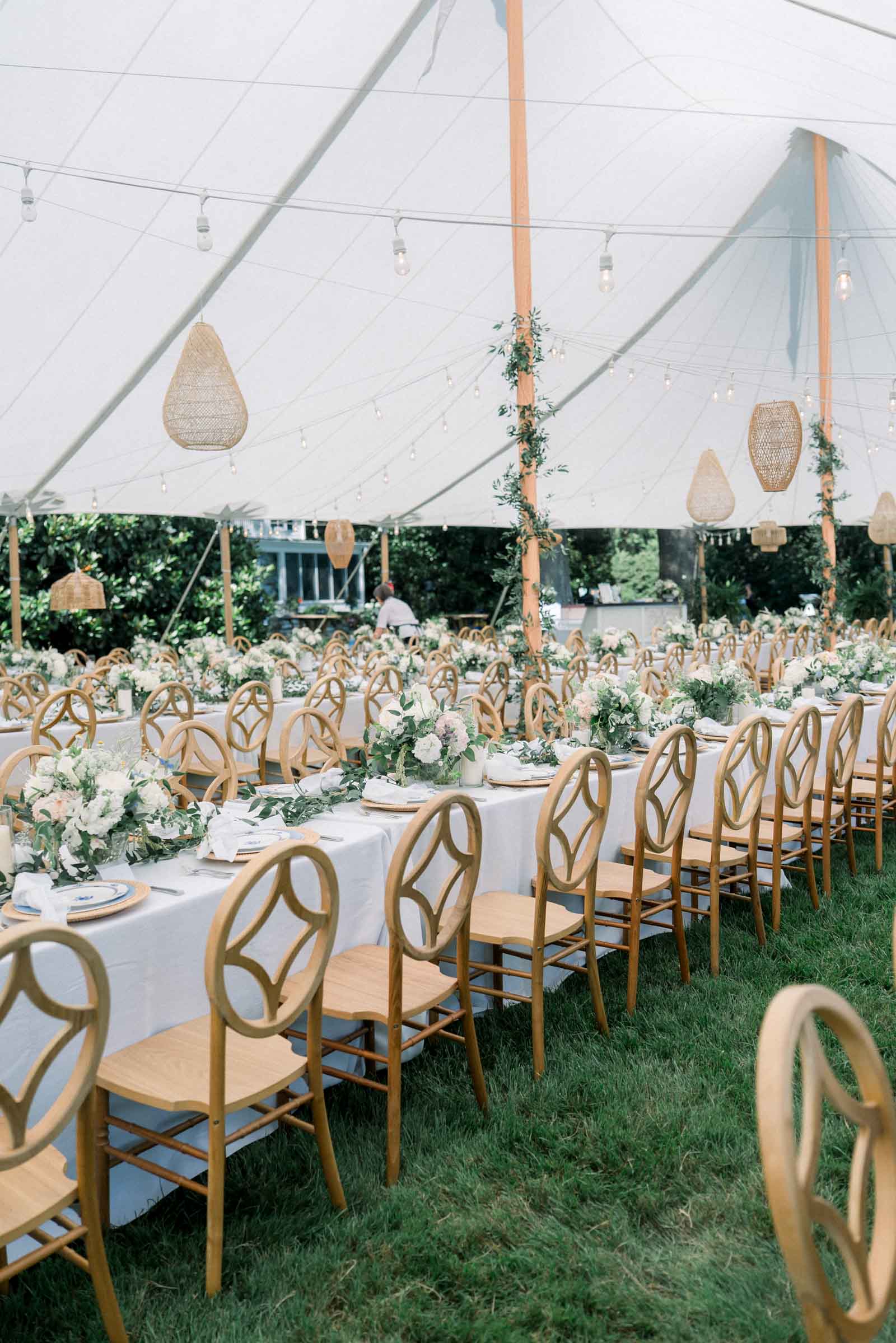 Gorgeous white tent wedding reception with wood diamond back chairs and hanging wicker lanterns