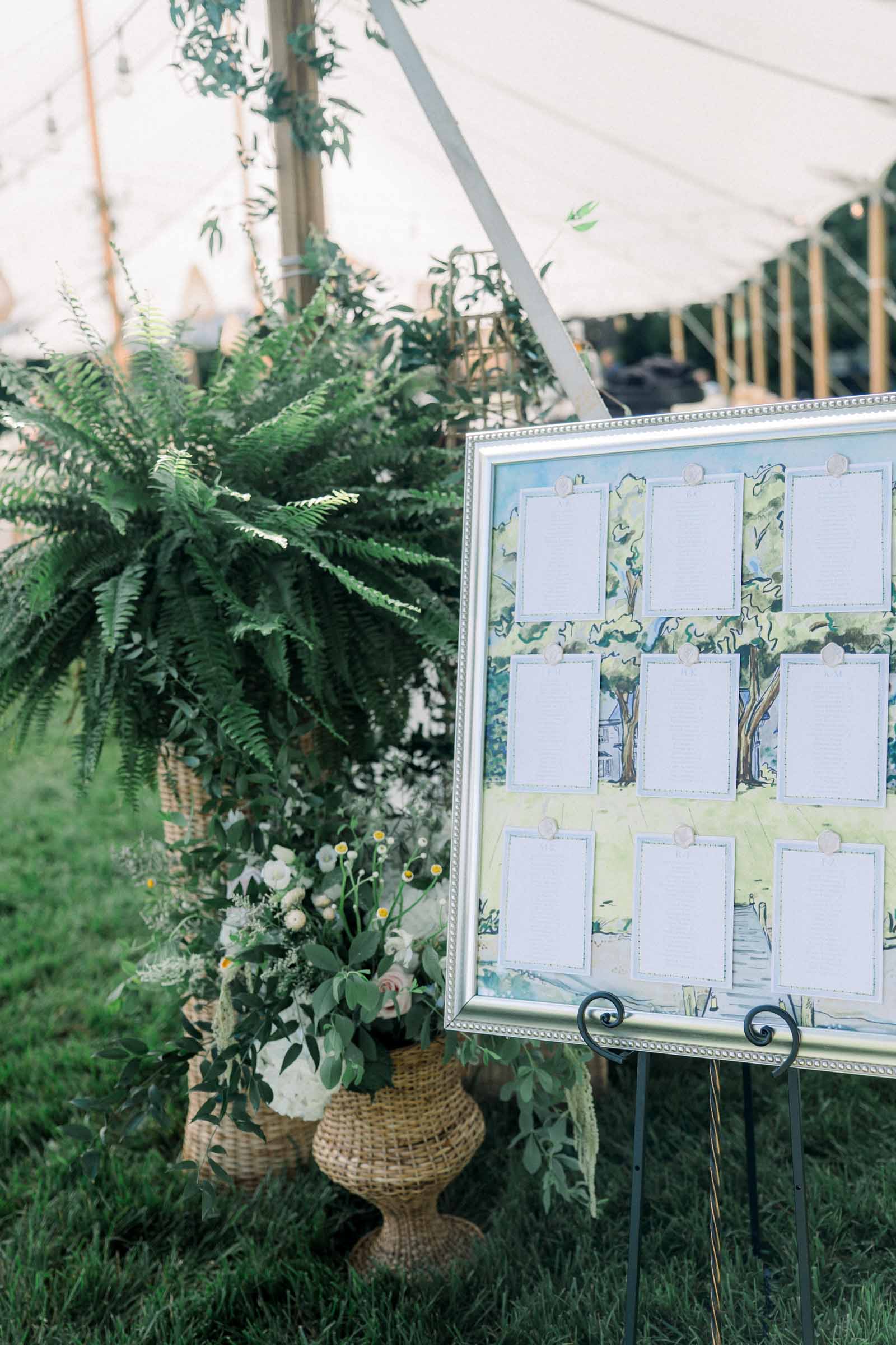 Large silver framed watercolor painting used for a wedding seating chart