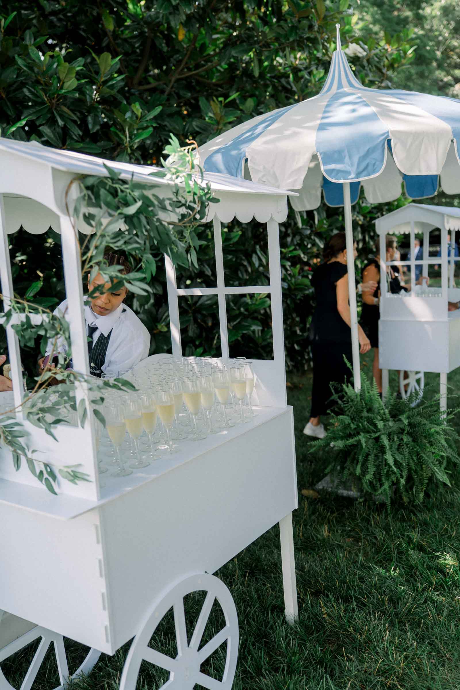Champagne cart with blue and white striped umbrellas