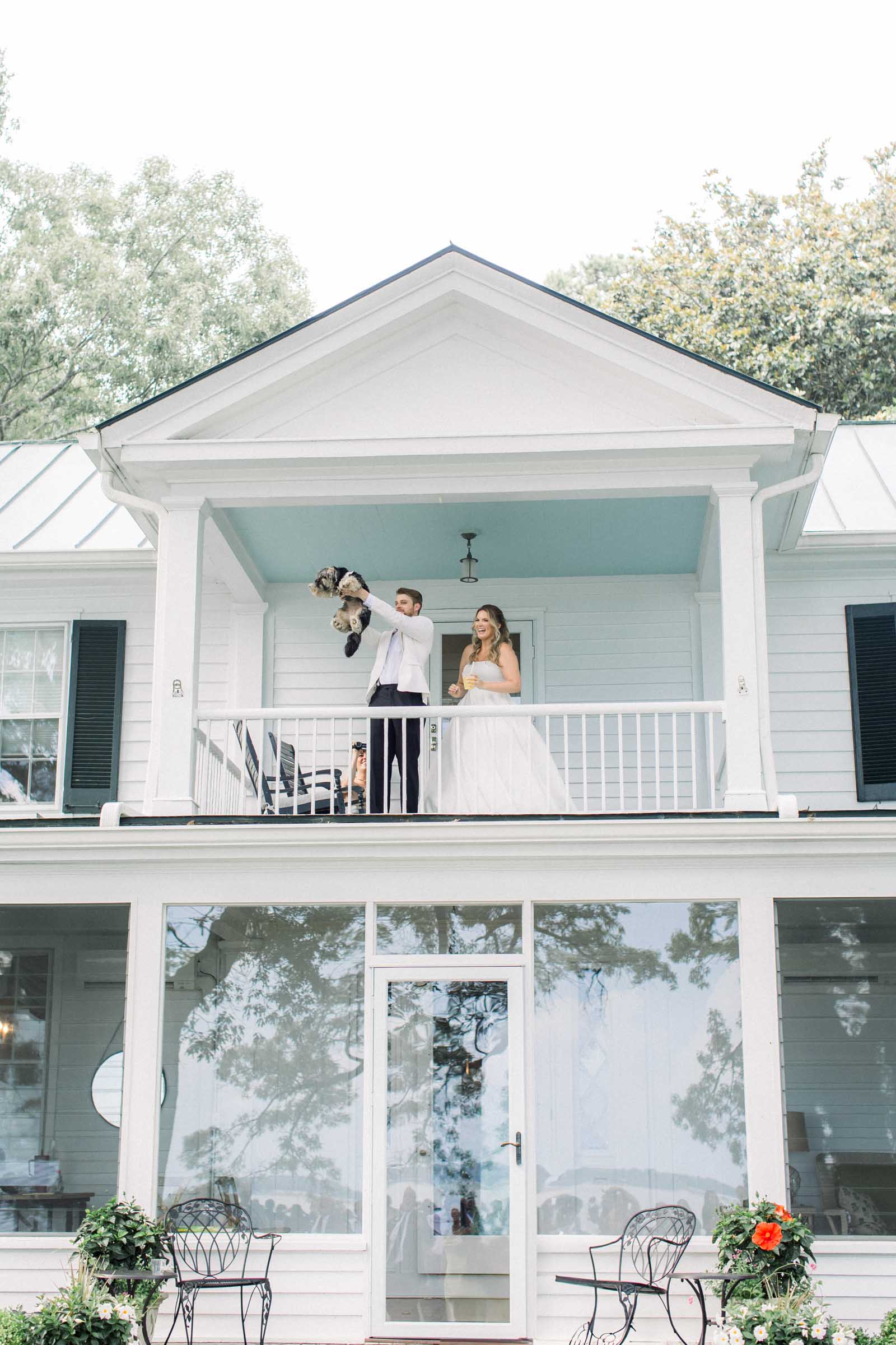Bride and groom holding their adorable dog like a Lion King Simba moment