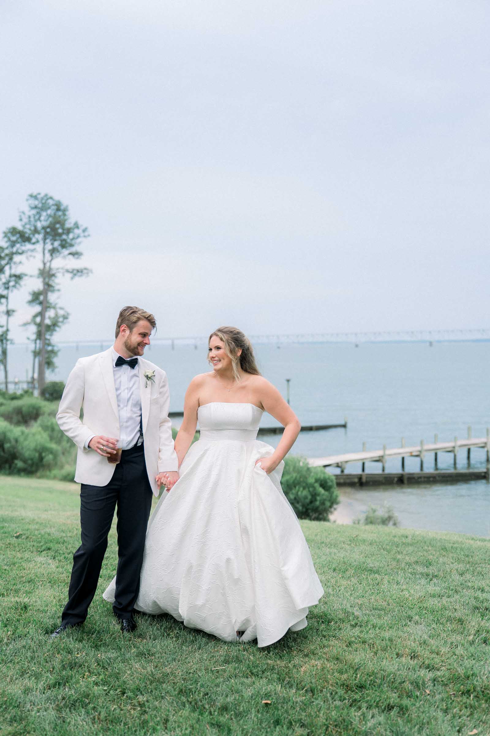 Bride and groom celebrating their wedding overlooking the Rappahannock River in Virginia