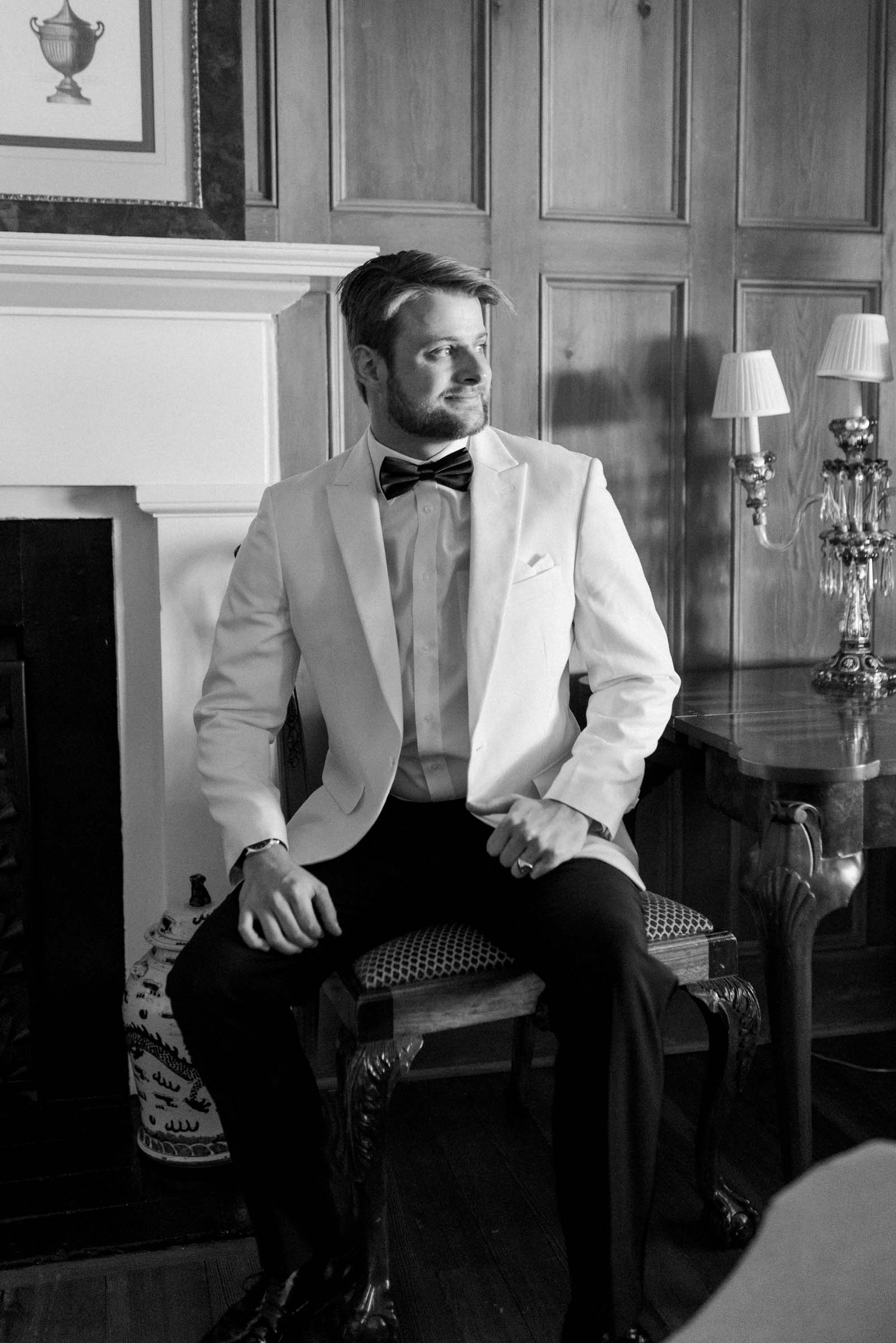 Groom wearing a white tuxedo for vintage wedding