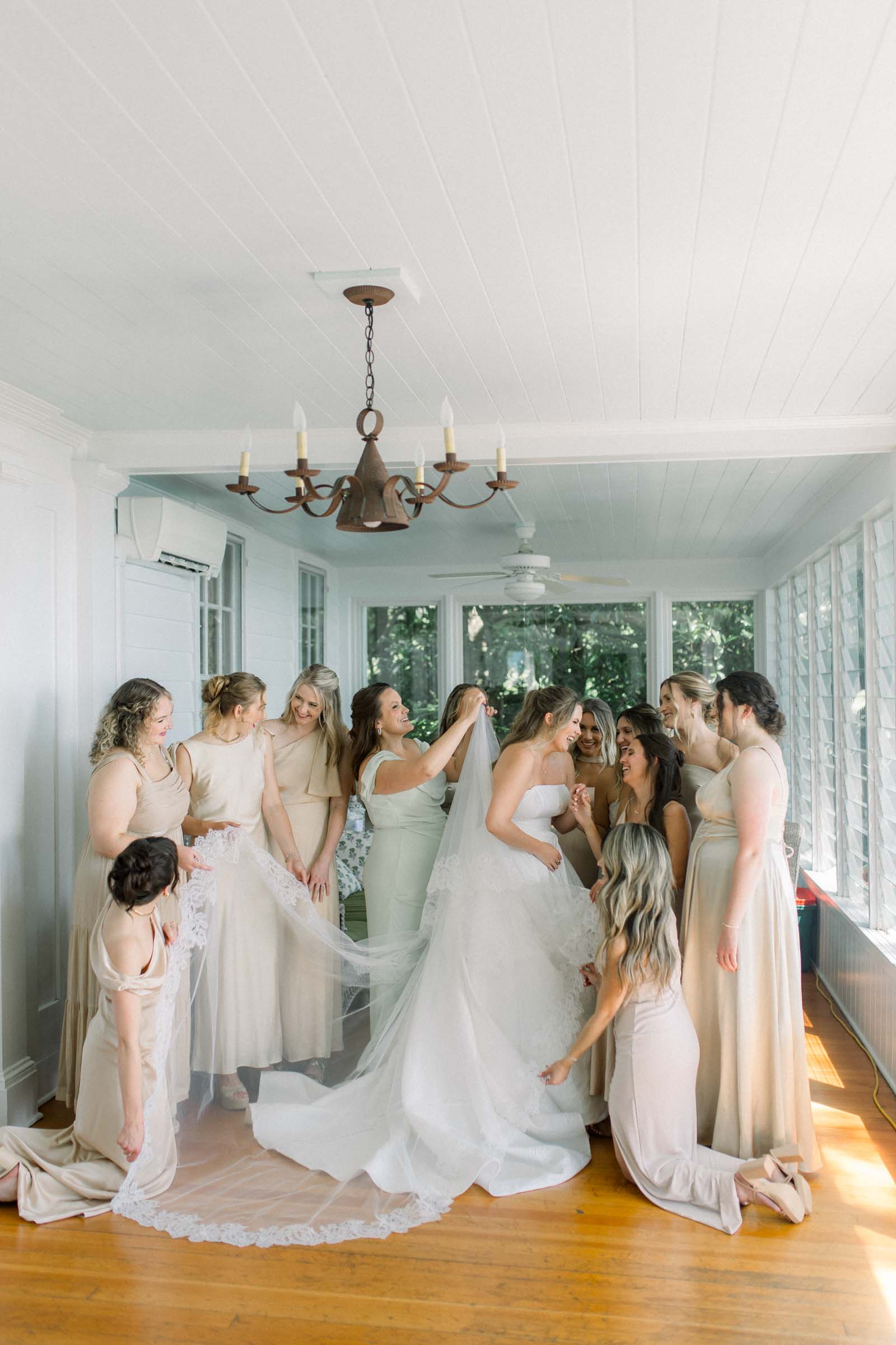Bride with her bridesmaids in neutral colored dresses